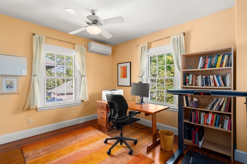 54 Arborway Boston, MA 02130 - Photo 12 of 29 a view of a workspace with furniture and a bookshelf