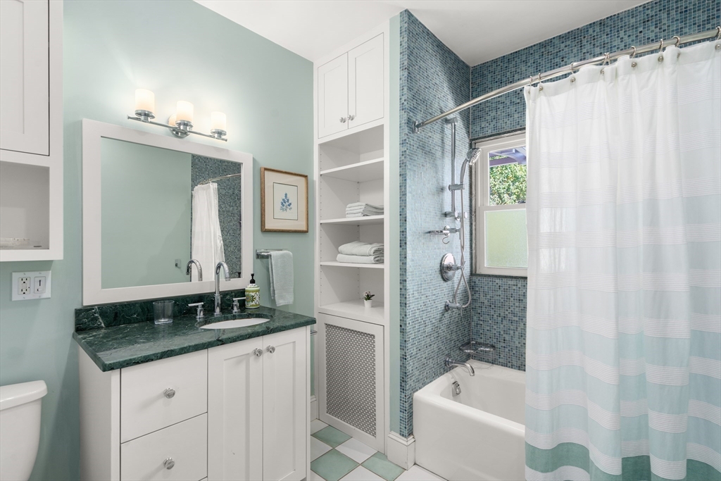 54 Arborway Boston, MA 02130 - Photo 13 of 29 a bathroom with a granite countertop sink a toilet and shower