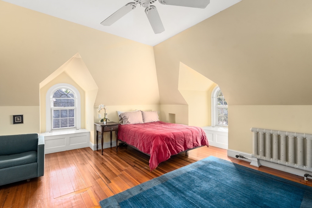 54 Arborway Boston, MA 02130 - Photo 18 of 29 a bedroom with a bed and a couch