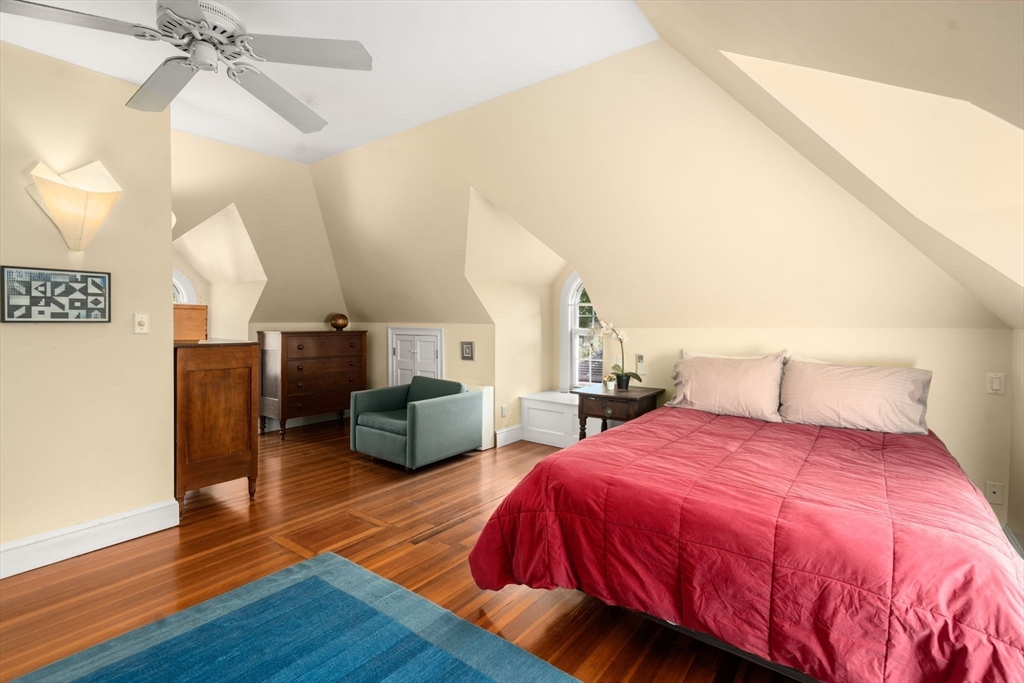 54 Arborway Boston, MA 02130 - Photo 19 of 29 a spacious bedroom with a bed and wooden floor