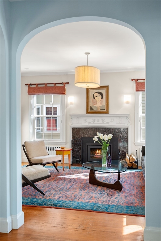 54 Arborway Boston, MA 02130 - Photo 2 of 29 a living room with furniture and a fireplace