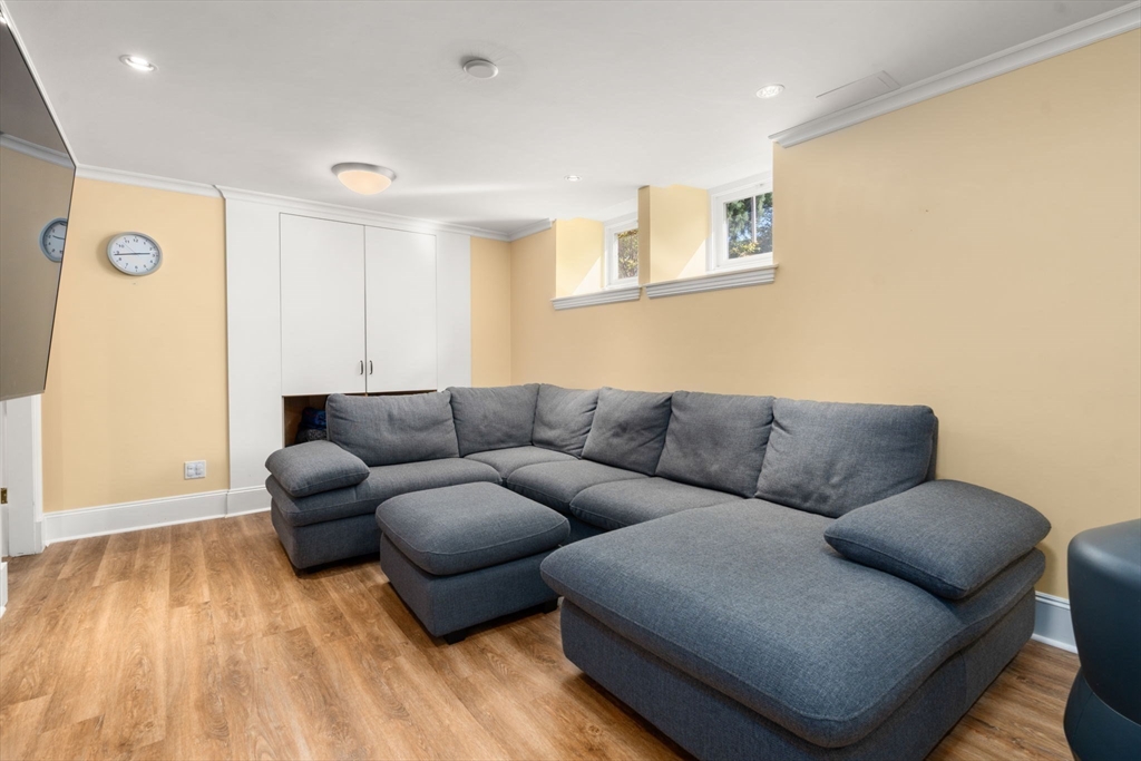 54 Arborway Boston, MA 02130 - Photo 22 of 29 a living room with furniture and a wooden floor