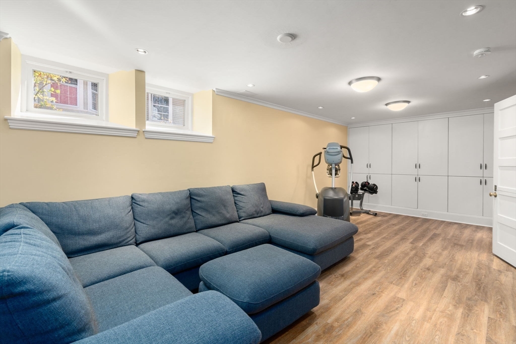 54 Arborway Boston, MA 02130 - Photo 23 of 29 a living room with furniture and a wooden floor
