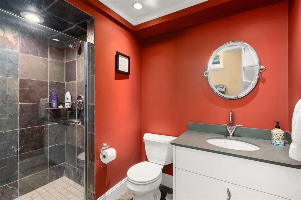 54 Arborway Boston, MA 02130 - Photo 24 of 29 a bathroom with a toilet a sink and mirror