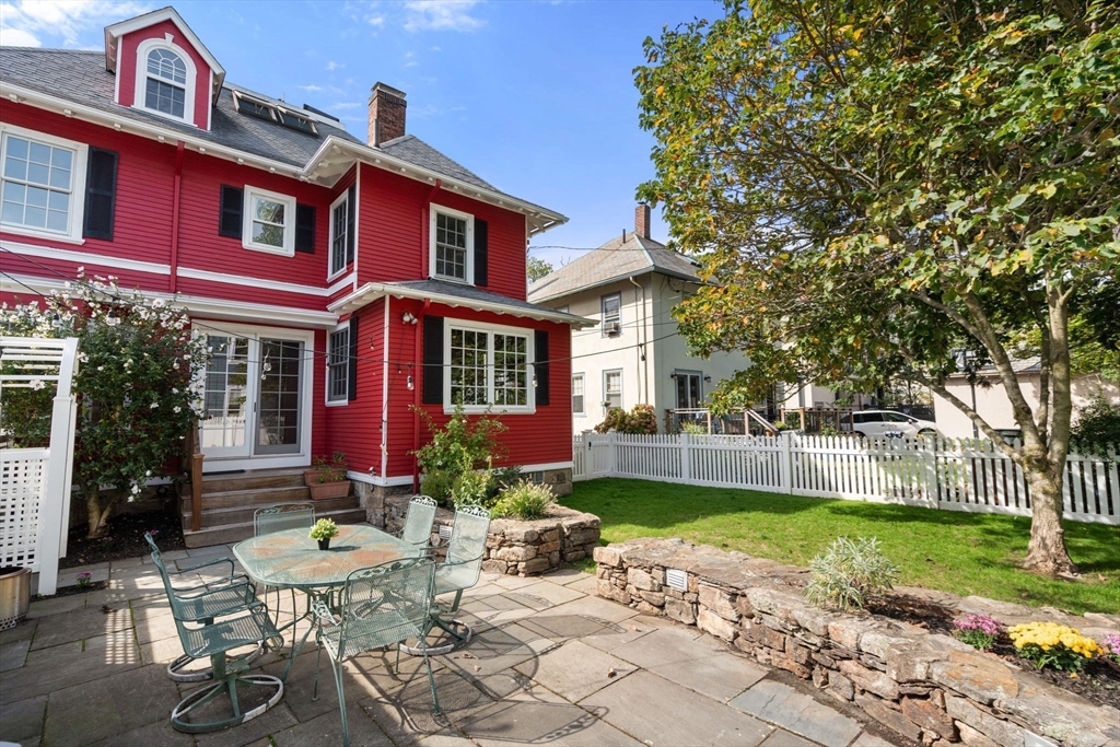 54 Arborway Boston, MA 02130 - Photo 25 of 29 a front view of a house with garden and porch
