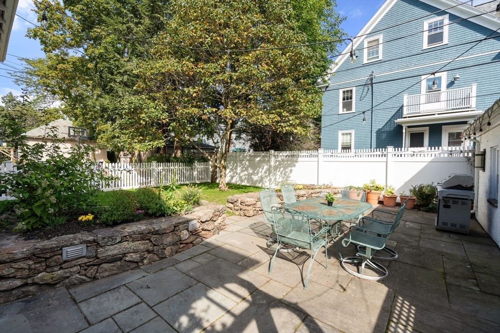 54 Arborway Boston, MA 02130 - Photo 26 of 29 a view of a patio with table and chairs and potted plants
