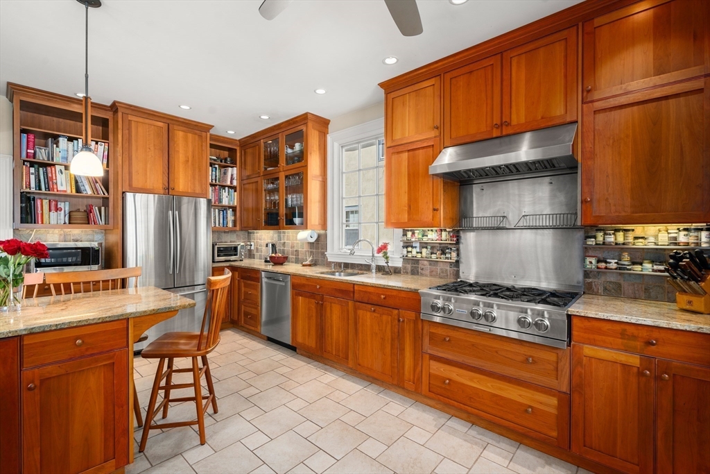 54 Arborway Boston, MA 02130 - Photo 8 of 29 a kitchen with stainless steel appliances granite countertop a stove a sink dishwasher and a refrigerator