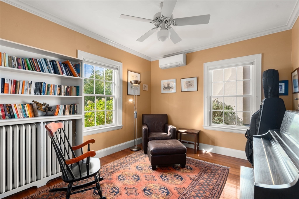 54 Arborway Boston, MA 02130 - Photo 10 of 29 a living room with furniture bookshelf and a window