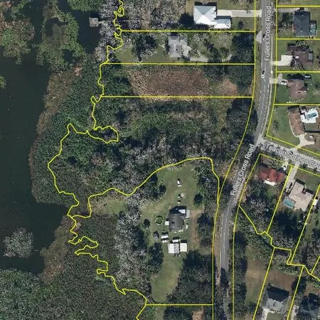 an aerial view of a houses with yard