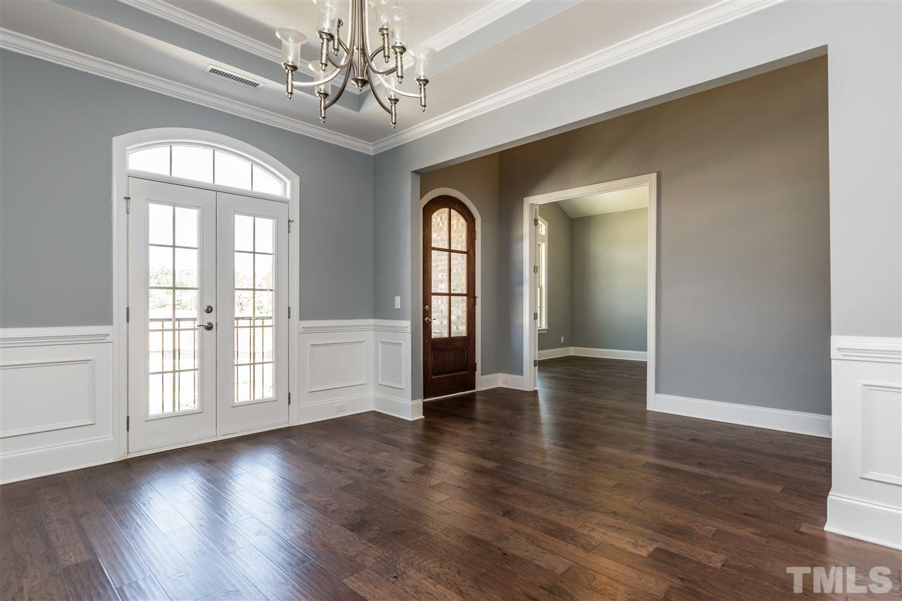 5273 Aleppo Lane, Unit 5 Raleigh, NC 27613 - Photo 2 of 24 a view of an empty room with wooden floor and a window