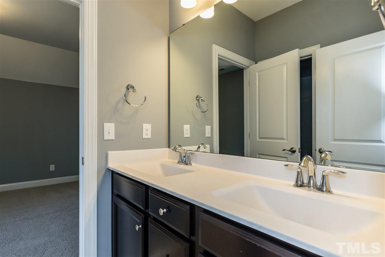 5273 Aleppo Lane, Unit 5 Raleigh, NC 27613 - Photo 15 of 24 a bathroom with a double vanity sink a and mirror
