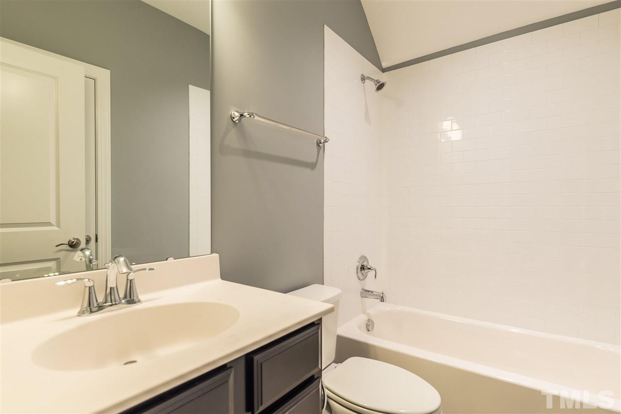 5273 Aleppo Lane, Unit 5 Raleigh, NC 27613 - Photo 19 of 24 a bathroom with a sink toilet vanity and shower