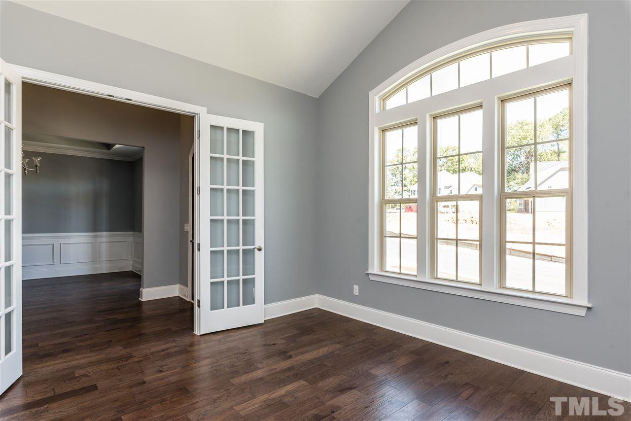 5273 Aleppo Lane, Unit 5 Raleigh, NC 27613 - Photo 3 of 24 a view of an empty room with wooden floor and a window
