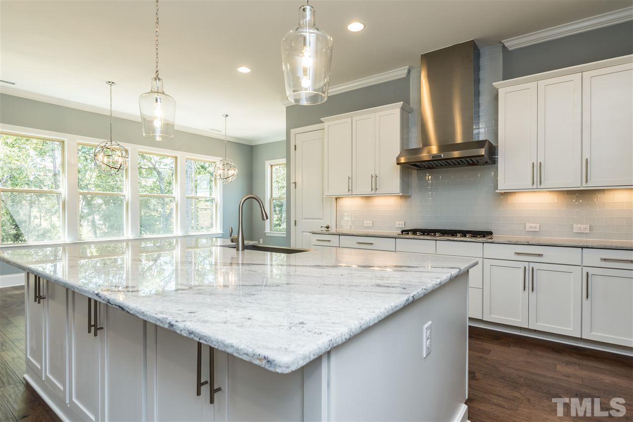 5273 Aleppo Lane, Unit 5 Raleigh, NC 27613 - Photo 6 of 24 a kitchen with granite countertop a sink a counter space appliances and cabinets