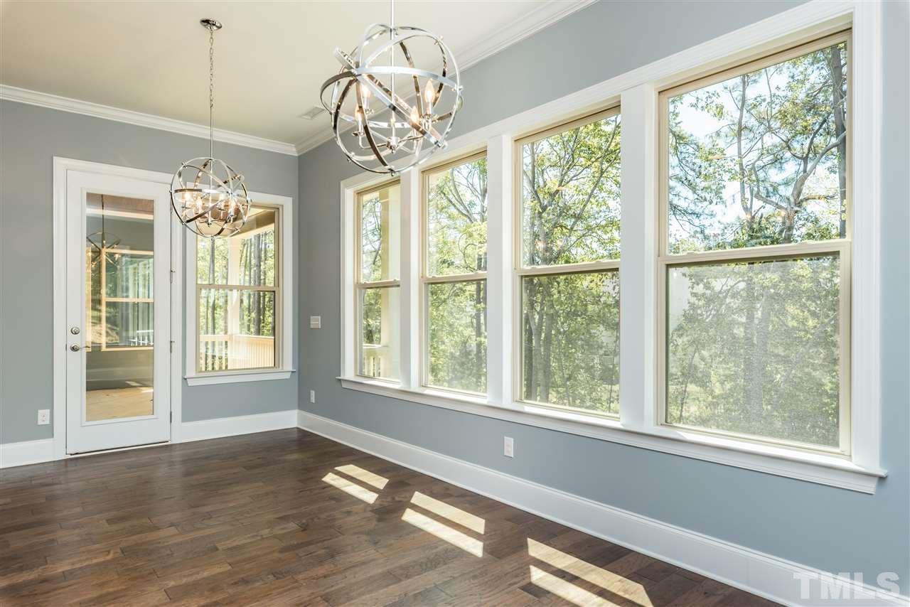 5273 Aleppo Lane, Unit 5 Raleigh, NC 27613 - Photo 8 of 24 a view of an empty room with wooden floor and a window