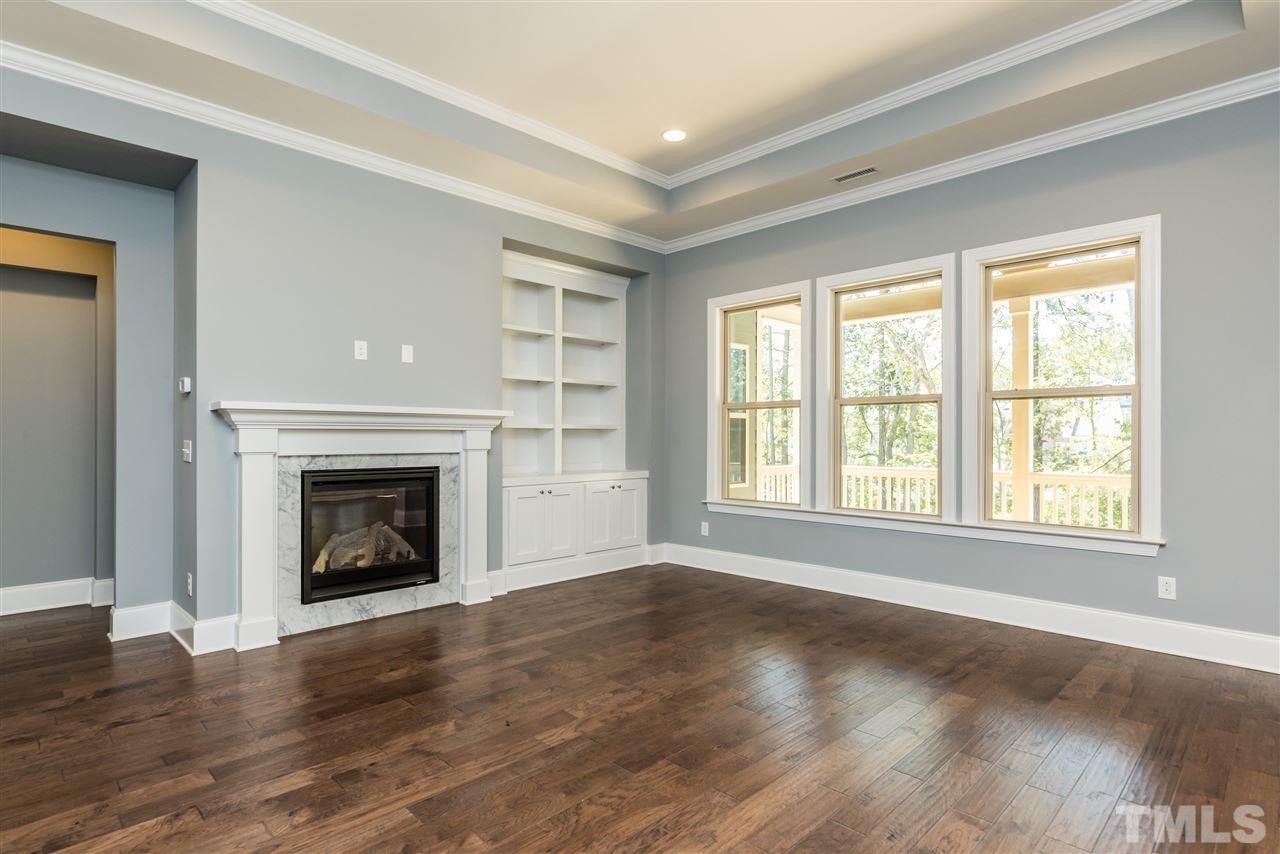 5273 Aleppo Lane, Unit 5 Raleigh, NC 27613 - Photo 10 of 24 an empty room with wooden floor fireplace and windows