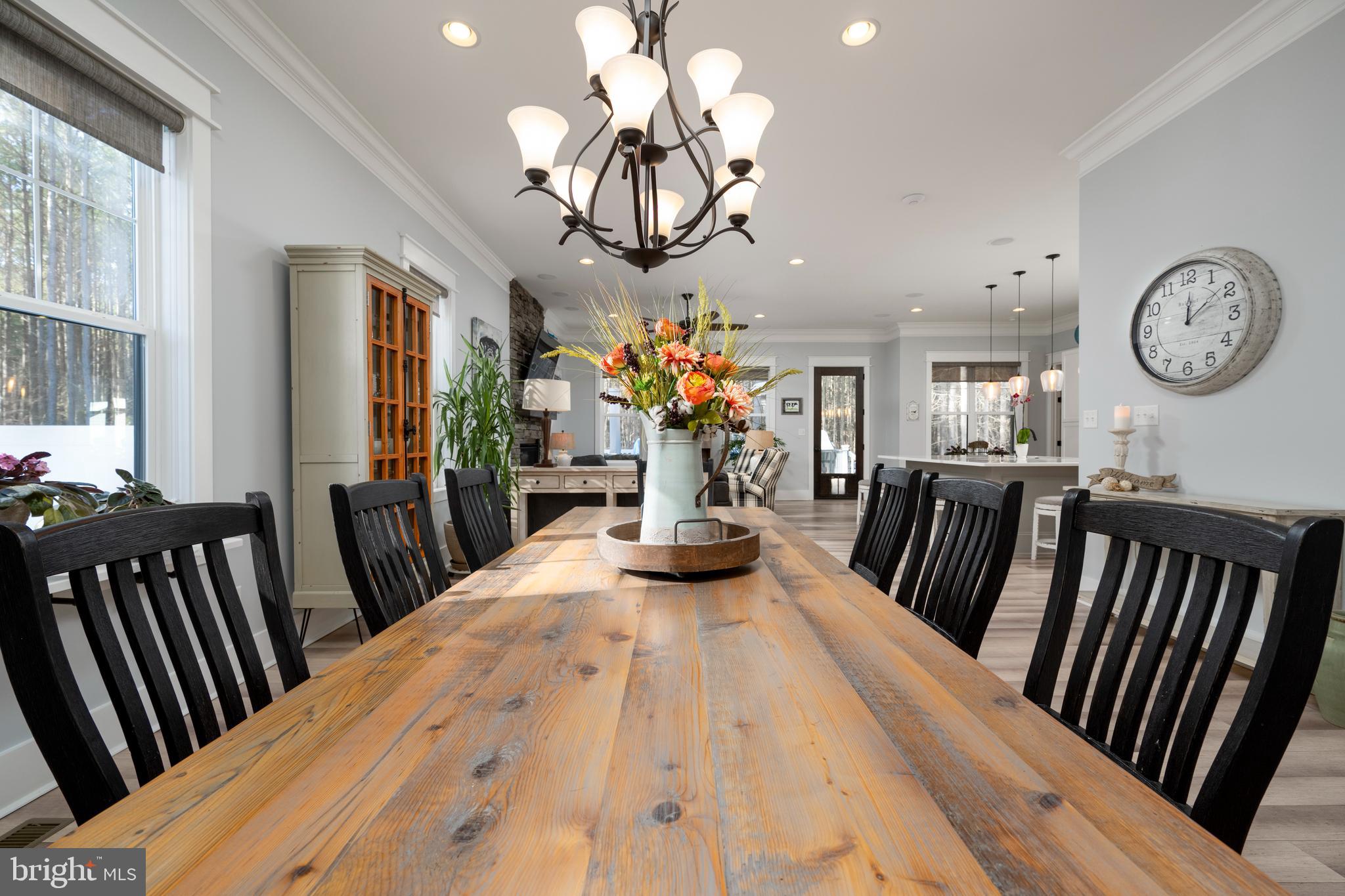 19668 Beaver Dam Road Lewes, DE 19958 - Photo 12 of 50 a view of a dining room with furniture chandelier and wooden floor