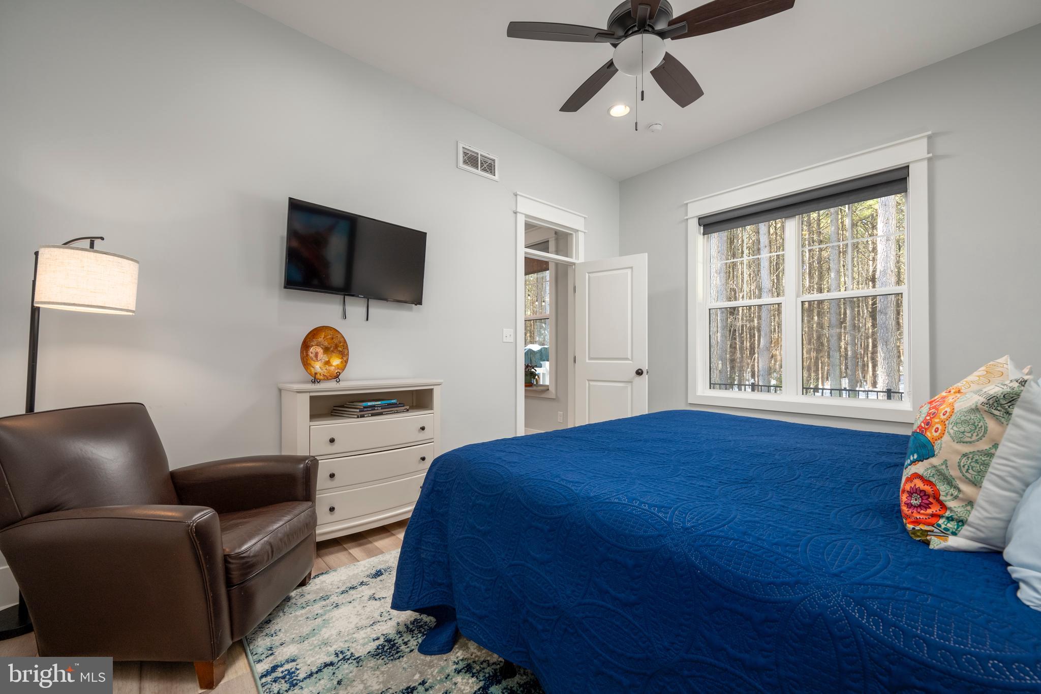 19668 Beaver Dam Road Lewes, DE 19958 - Photo 13 of 50 a bedroom with a bed and flat screen tv