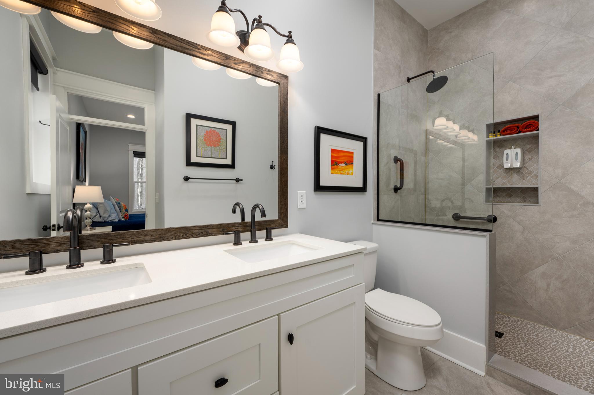 19668 Beaver Dam Road Lewes, DE 19958 - Photo 15 of 50 a bathroom with a toilet a sink and mirror