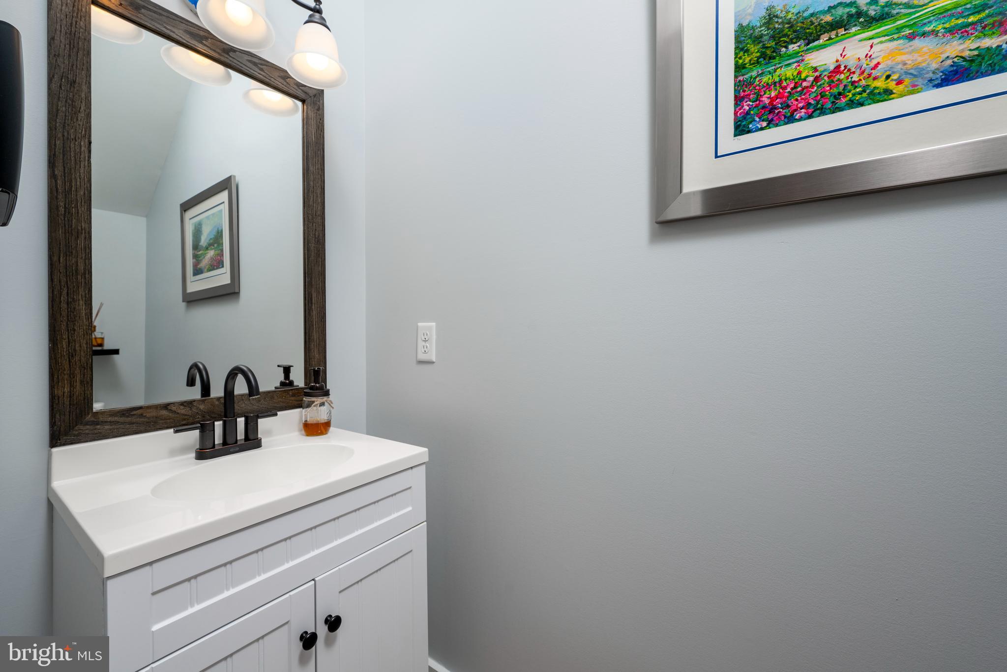 19668 Beaver Dam Road Lewes, DE 19958 - Photo 19 of 50 a bathroom with a sink and a mirror