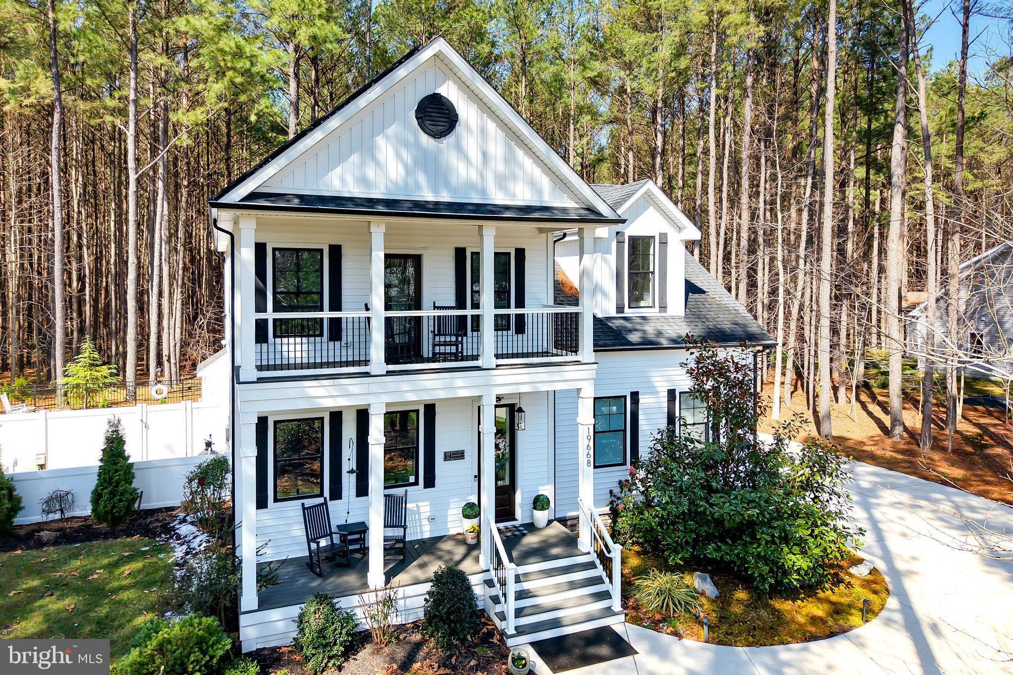 19668 Beaver Dam Road Lewes, DE 19958 - Photo 3 of 50 a front view of a house with a yard and garage