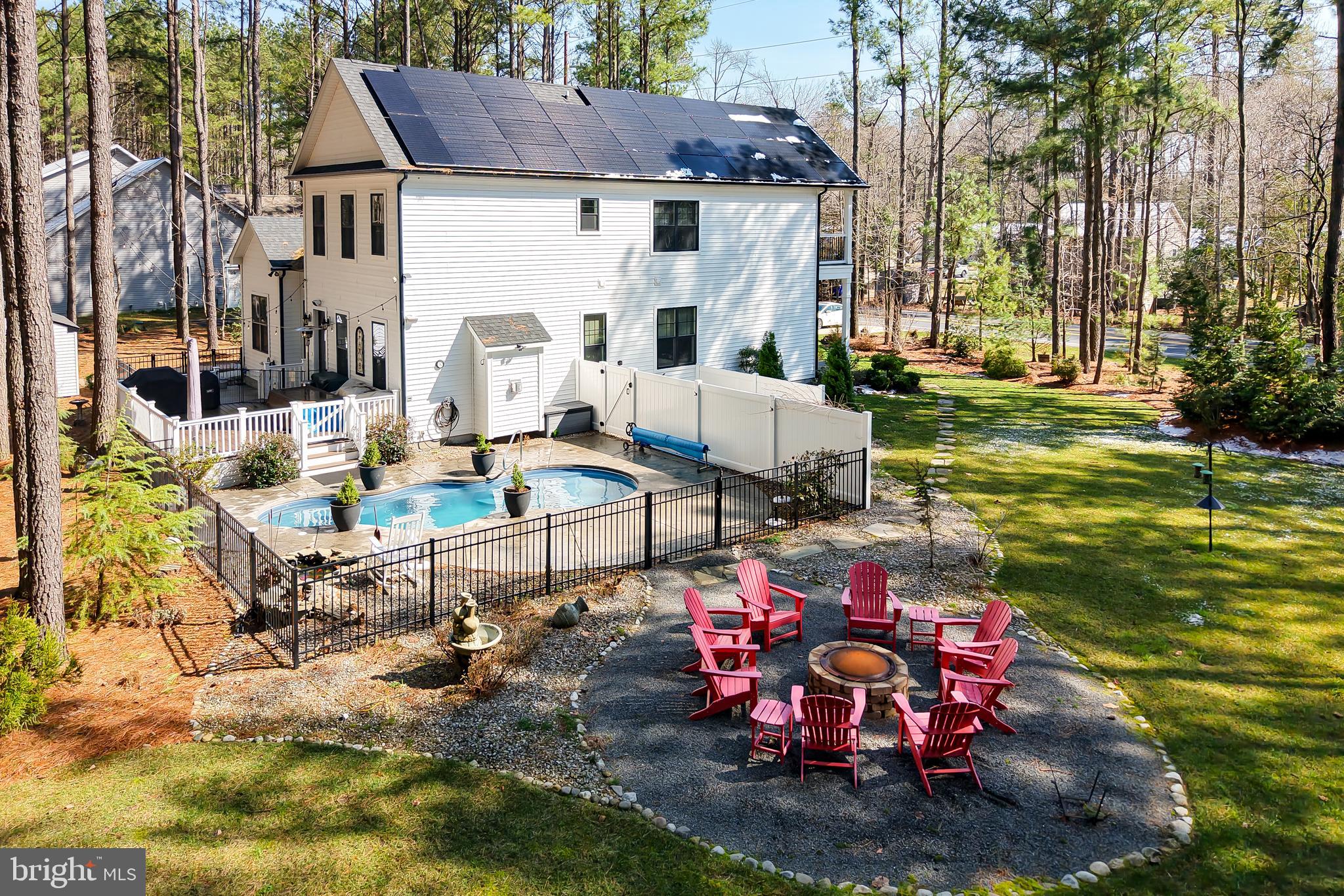 19668 Beaver Dam Road Lewes, DE 19958 - Photo 35 of 50 a view of a patio with table and chairs under an umbrella
