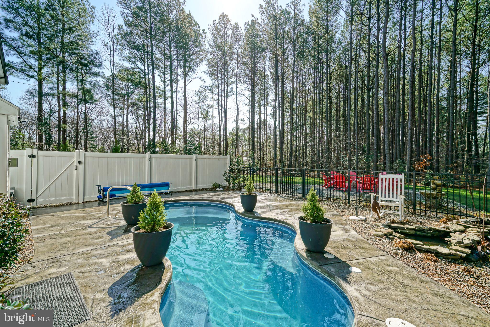 19668 Beaver Dam Road Lewes, DE 19958 - Photo 40 of 50 a wooden bench sitting in the middle of a yard