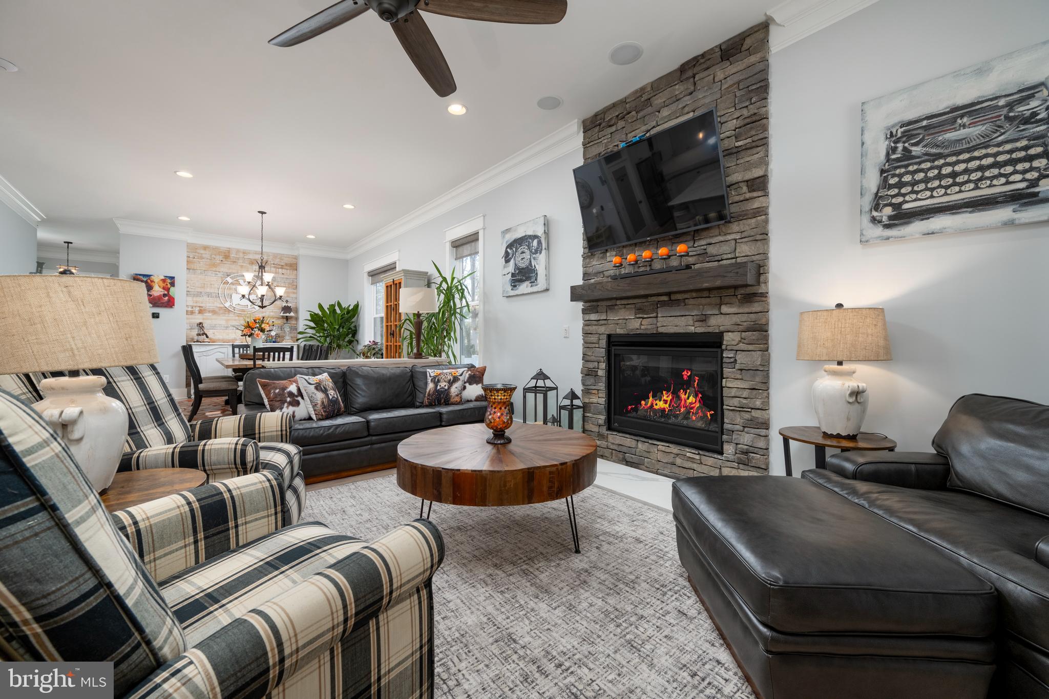 19668 Beaver Dam Road Lewes, DE 19958 - Photo 9 of 50 a living room with furniture a flat screen tv and a fireplace