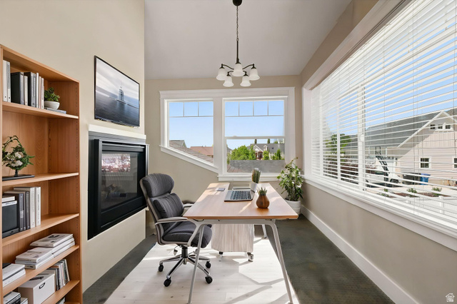 580 North 300 East Logan, UT 84321 - Photo 50 of 74 Versatile room featuring a built-in fireplace, natural wood-finish shelving, and expansive windows