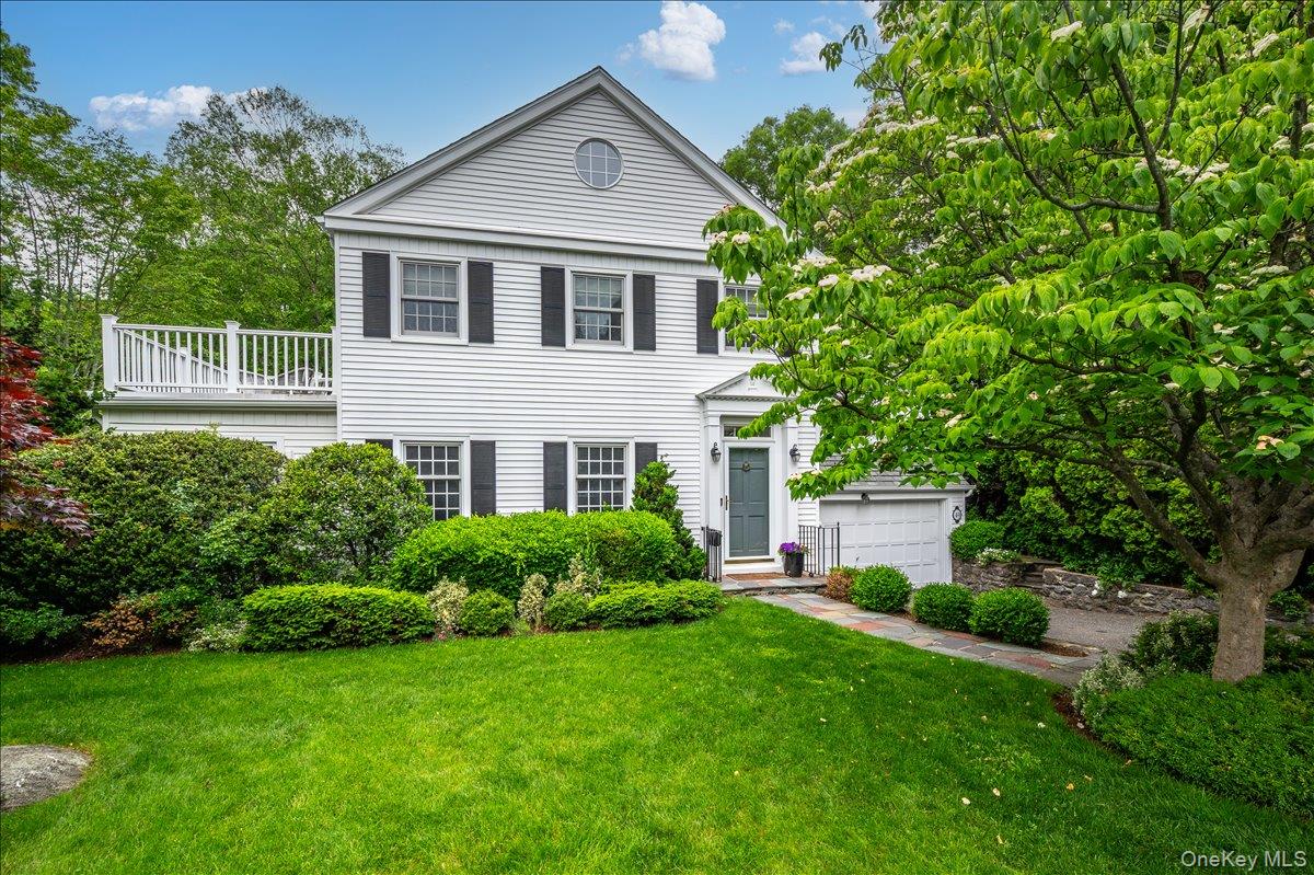 49 Eton Road Larchmont, NY 10538 - Photo 2 of 34 a front view of a house with a yard and trees