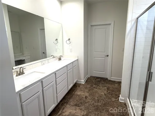 a bathroom with a sink a mirror and a vanity