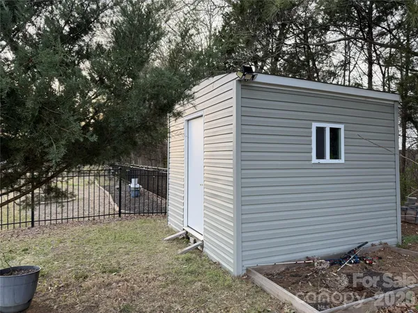 a view of a backyard with a deck and a garden