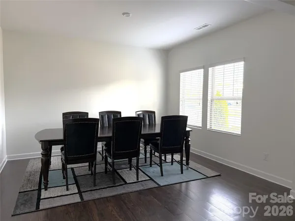 a view of a dining room with furniture and a window