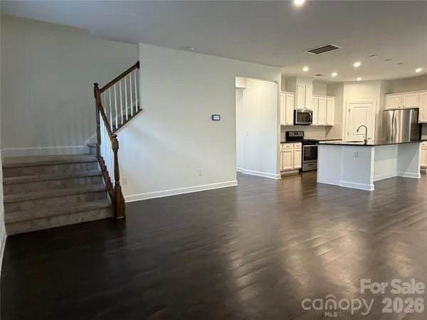 a view of kitchen with wooden floor and electronic appliances