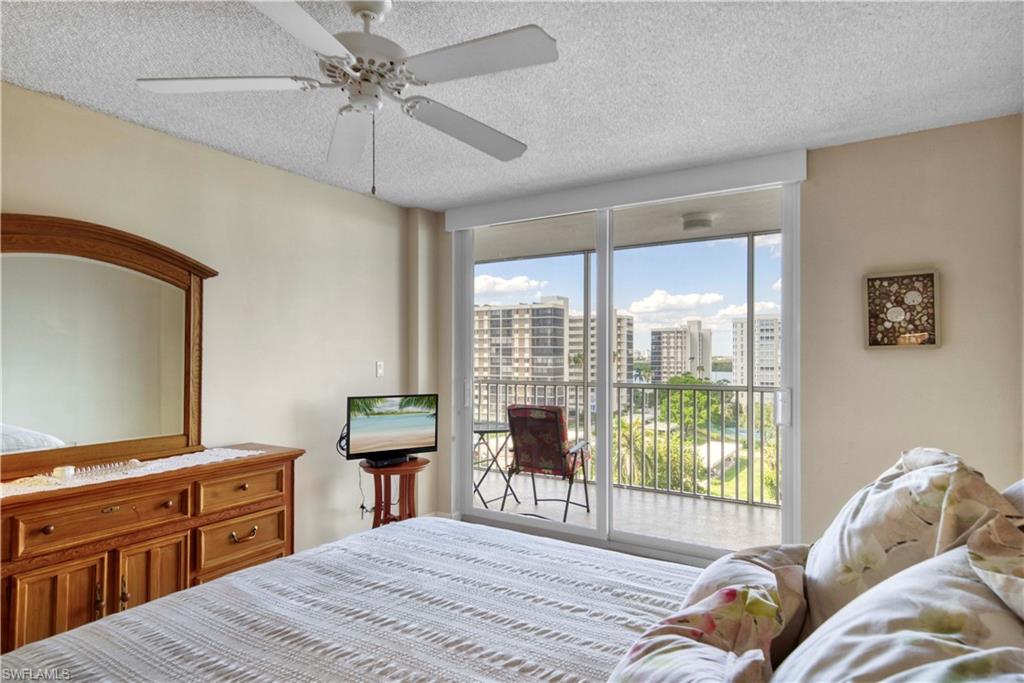 3 Bluebill Avenue, Unit 808 Naples, FL 34108 - Photo 21 of 25 a bed room with a bed and a television