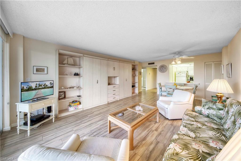 3 Bluebill Avenue, Unit 808 Naples, FL 34108 - Photo 8 of 25 a living room with furniture and a wooden floor