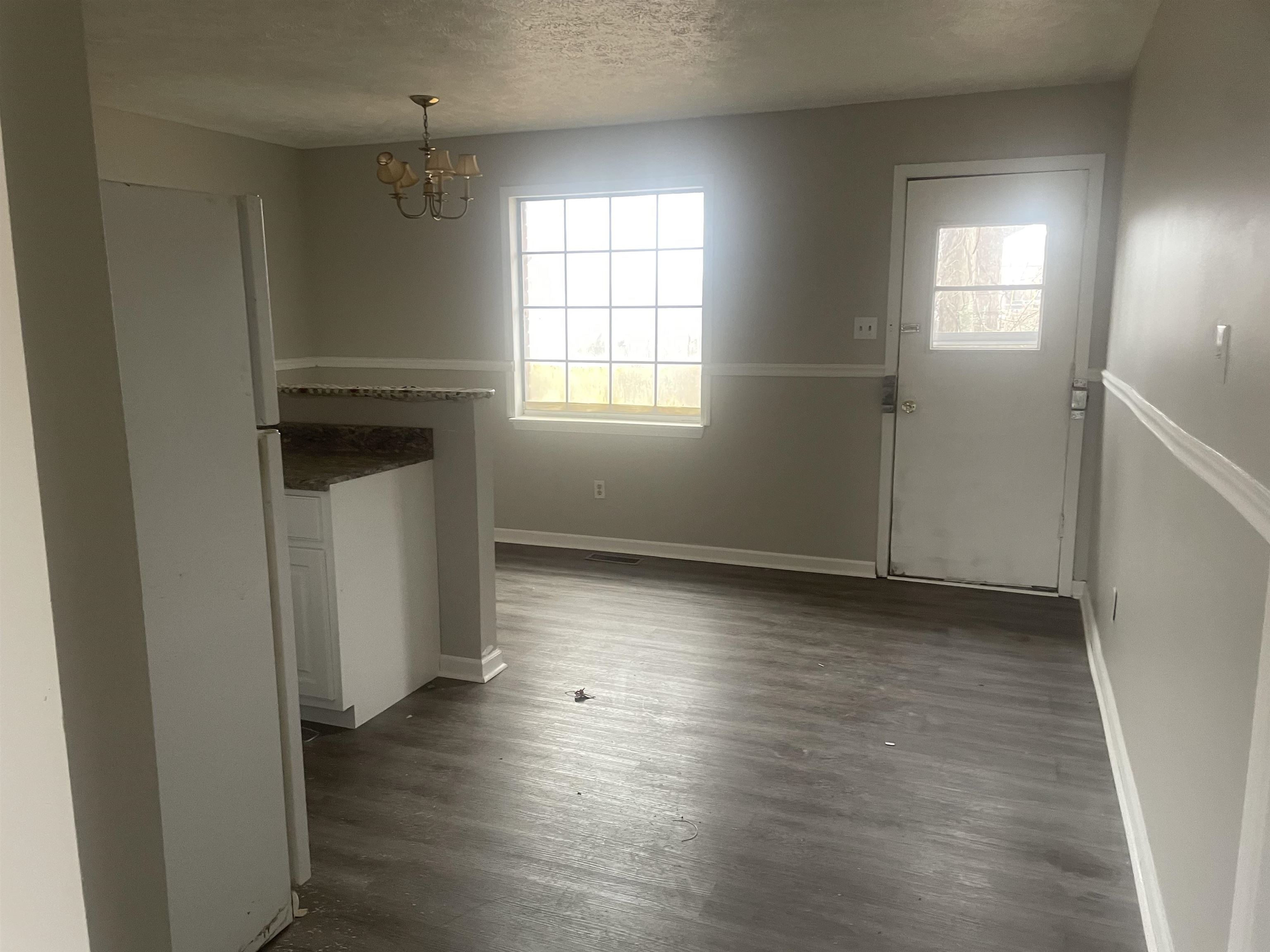 54 Cinnamon Drive Jackson, TN 38305 - Photo 6 of 7 an empty room with wooden floor and windows