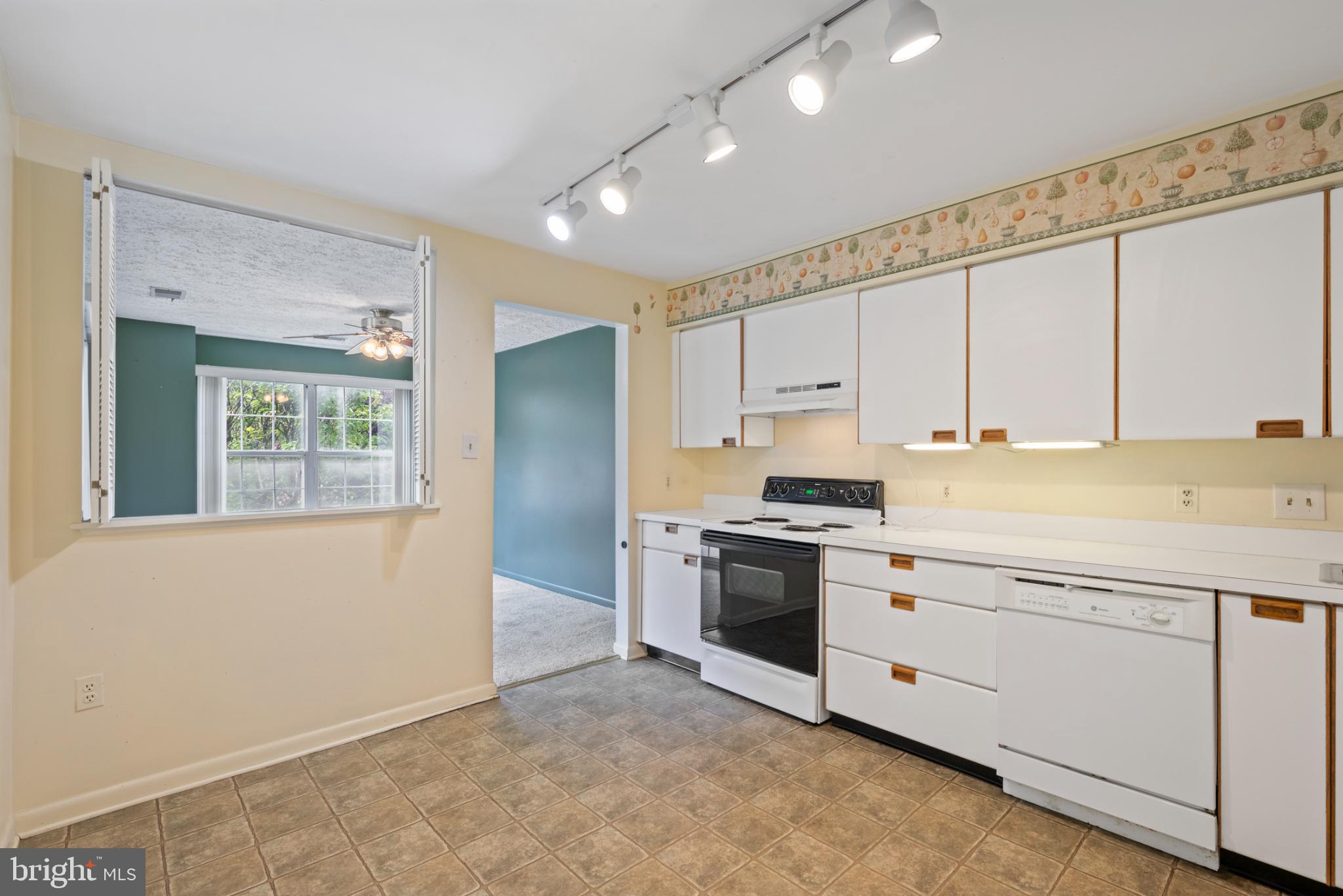 2201 Woodbox Lane, Unit 2201B Baltimore, MD 21209 - Photo 14 of 45 a kitchen with granite countertop white cabinets and stainless steel appliances