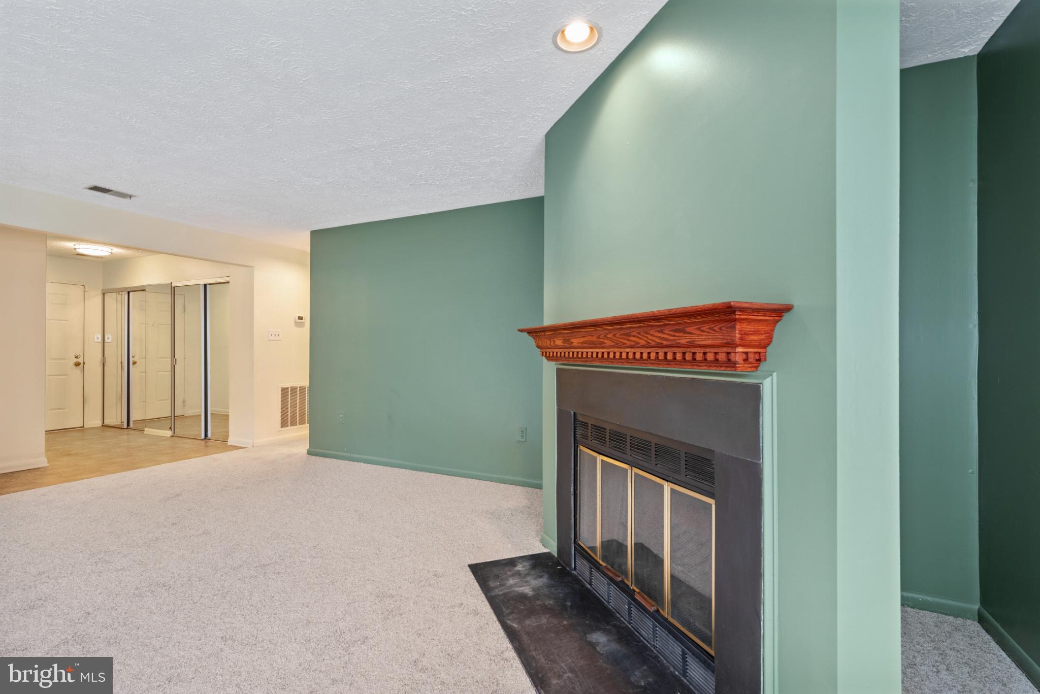 2201 Woodbox Lane, Unit 2201B Baltimore, MD 21209 - Photo 15 of 45 a view of an empty room with wooden floor and a window