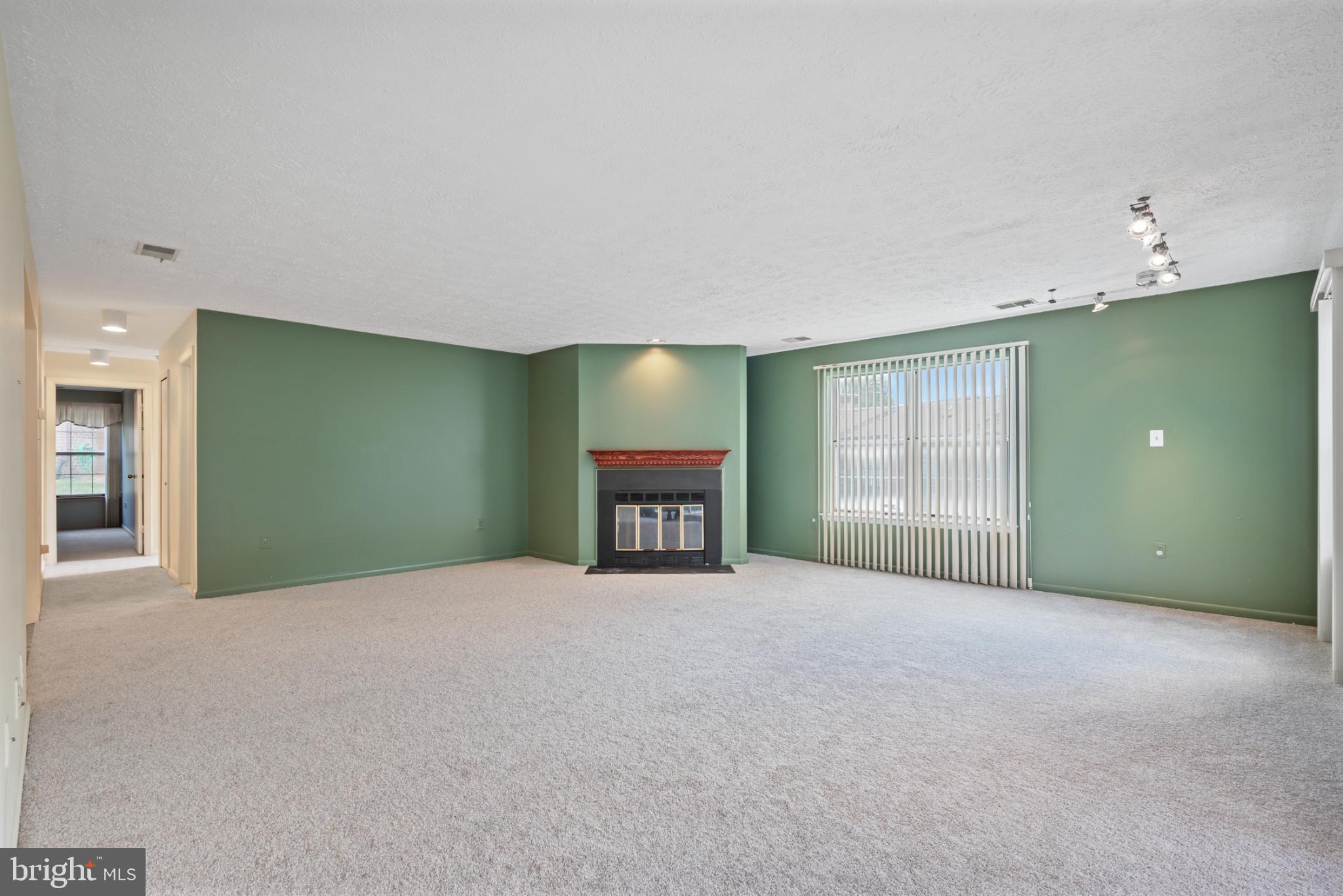 2201 Woodbox Lane, Unit 2201B Baltimore, MD 21209 - Photo 17 of 45 a view of an empty room with a fireplace