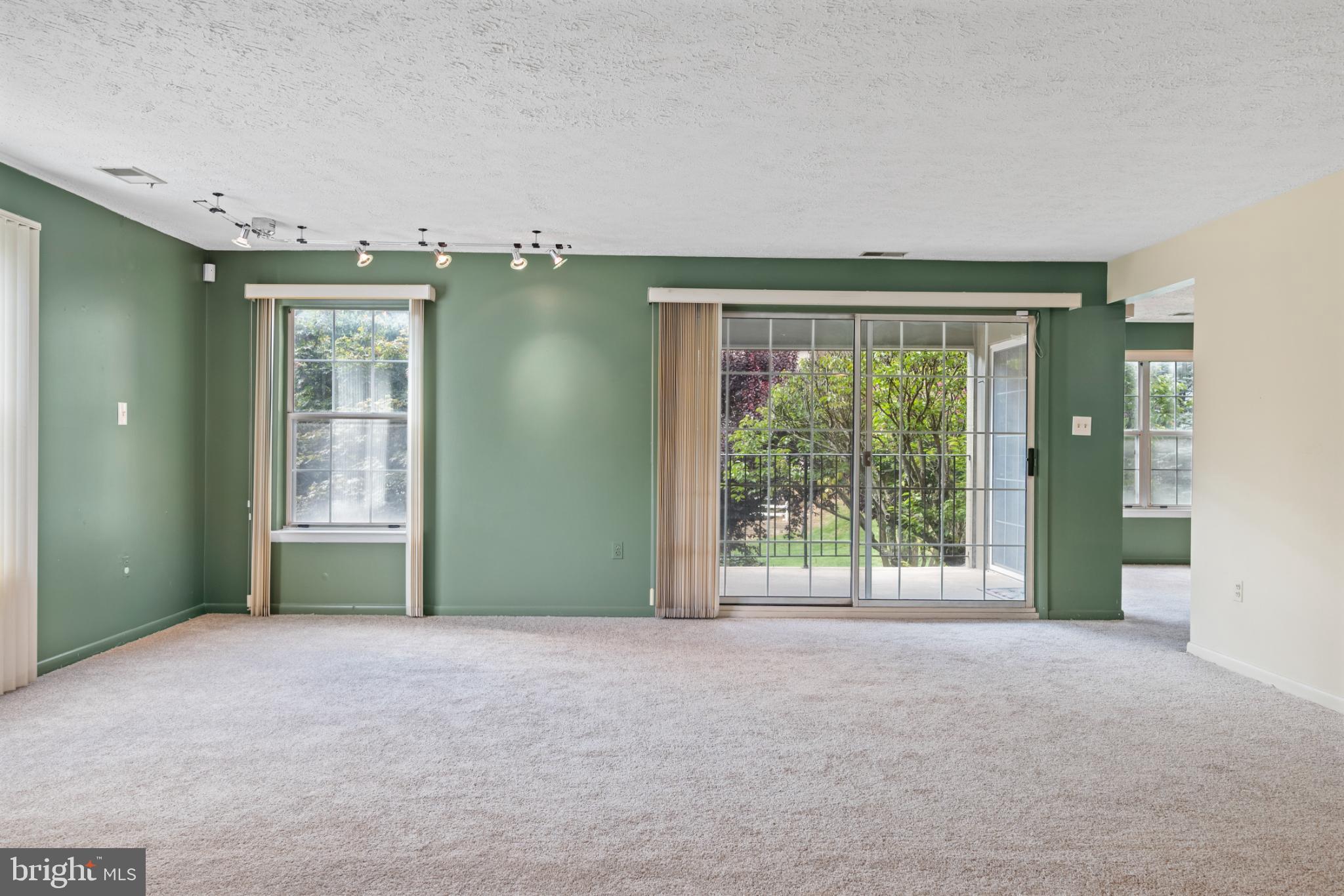 2201 Woodbox Lane, Unit 2201B Baltimore, MD 21209 - Photo 19 of 45 a view of an empty room with a balcony