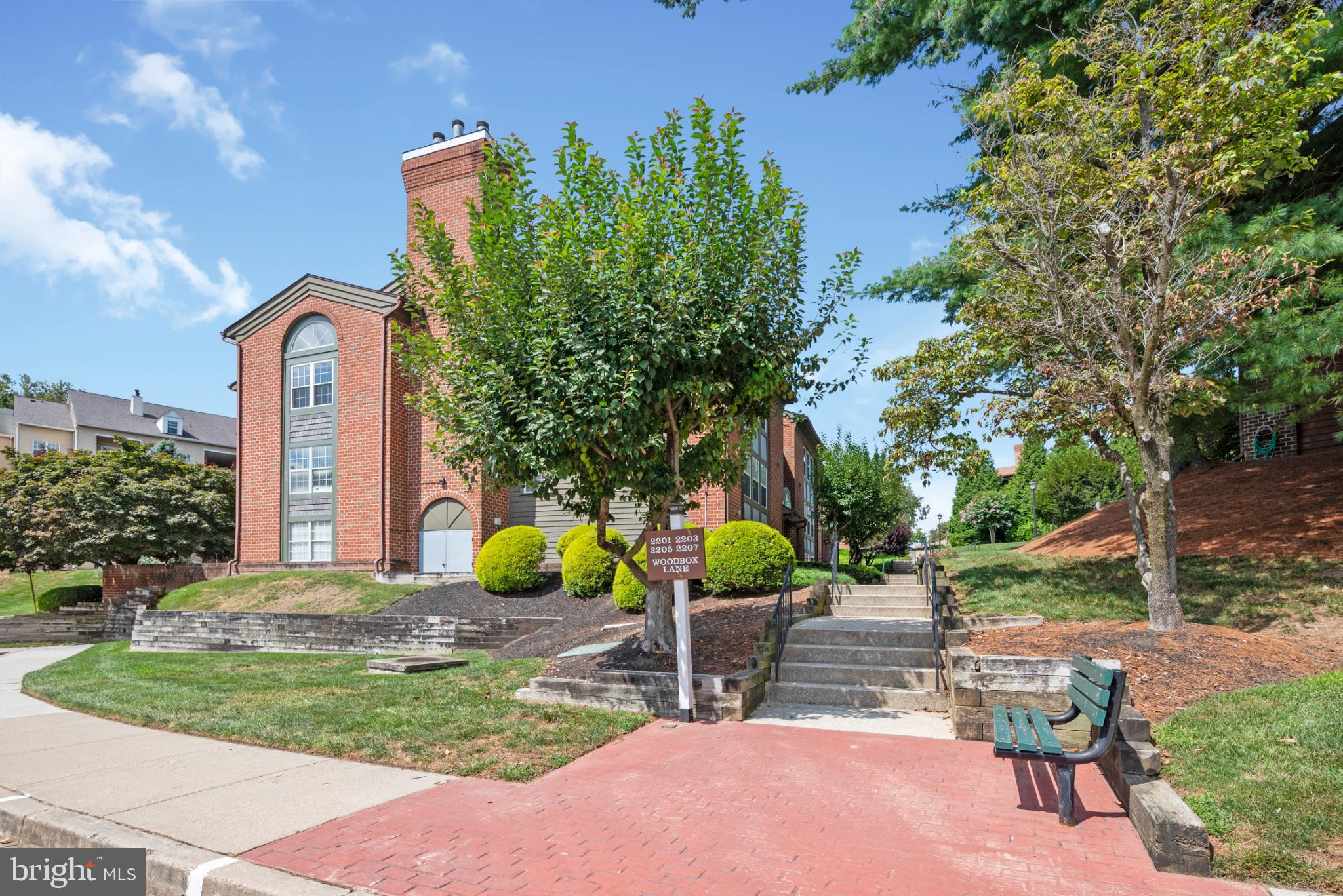 2201 Woodbox Lane, Unit 2201B Baltimore, MD 21209 - Photo 2 of 45 a view of patio with a table and chairs under an umbrella