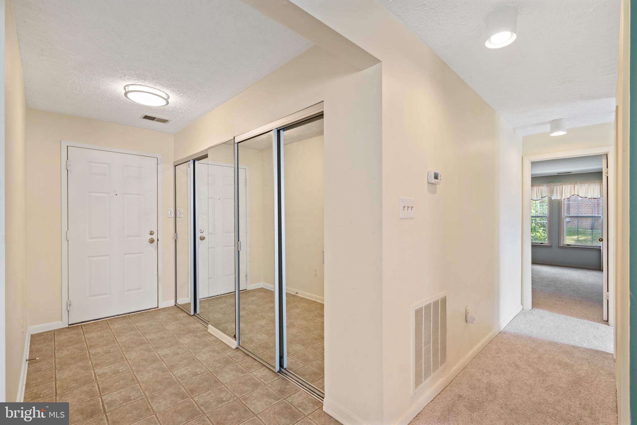 2201 Woodbox Lane, Unit 2201B Baltimore, MD 21209 - Photo 22 of 45 a view of a hallway with wooden floor and bathroom
