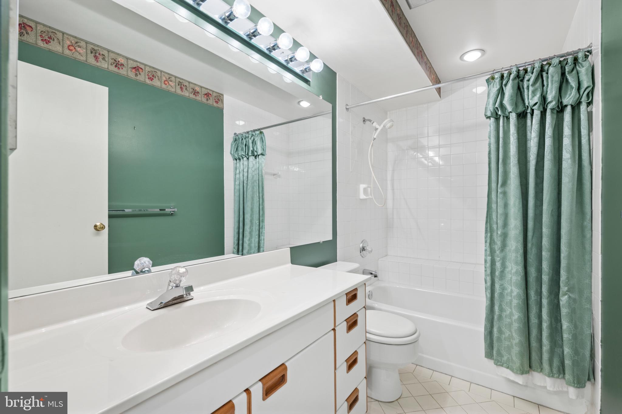 2201 Woodbox Lane, Unit 2201B Baltimore, MD 21209 - Photo 25 of 45 a bathroom with a sink a toilet and shower
