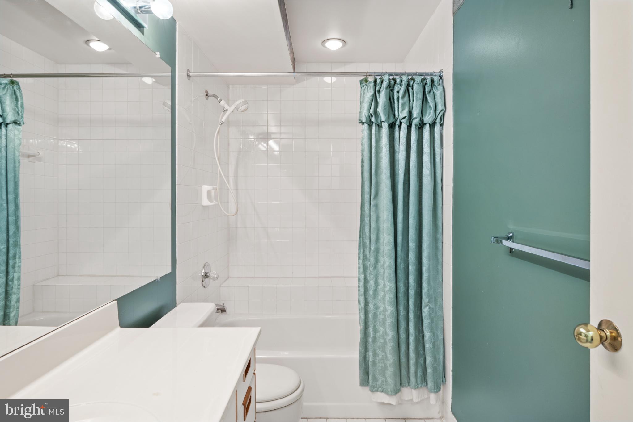 2201 Woodbox Lane, Unit 2201B Baltimore, MD 21209 - Photo 26 of 45 a bathroom with a toilet a sink and shower