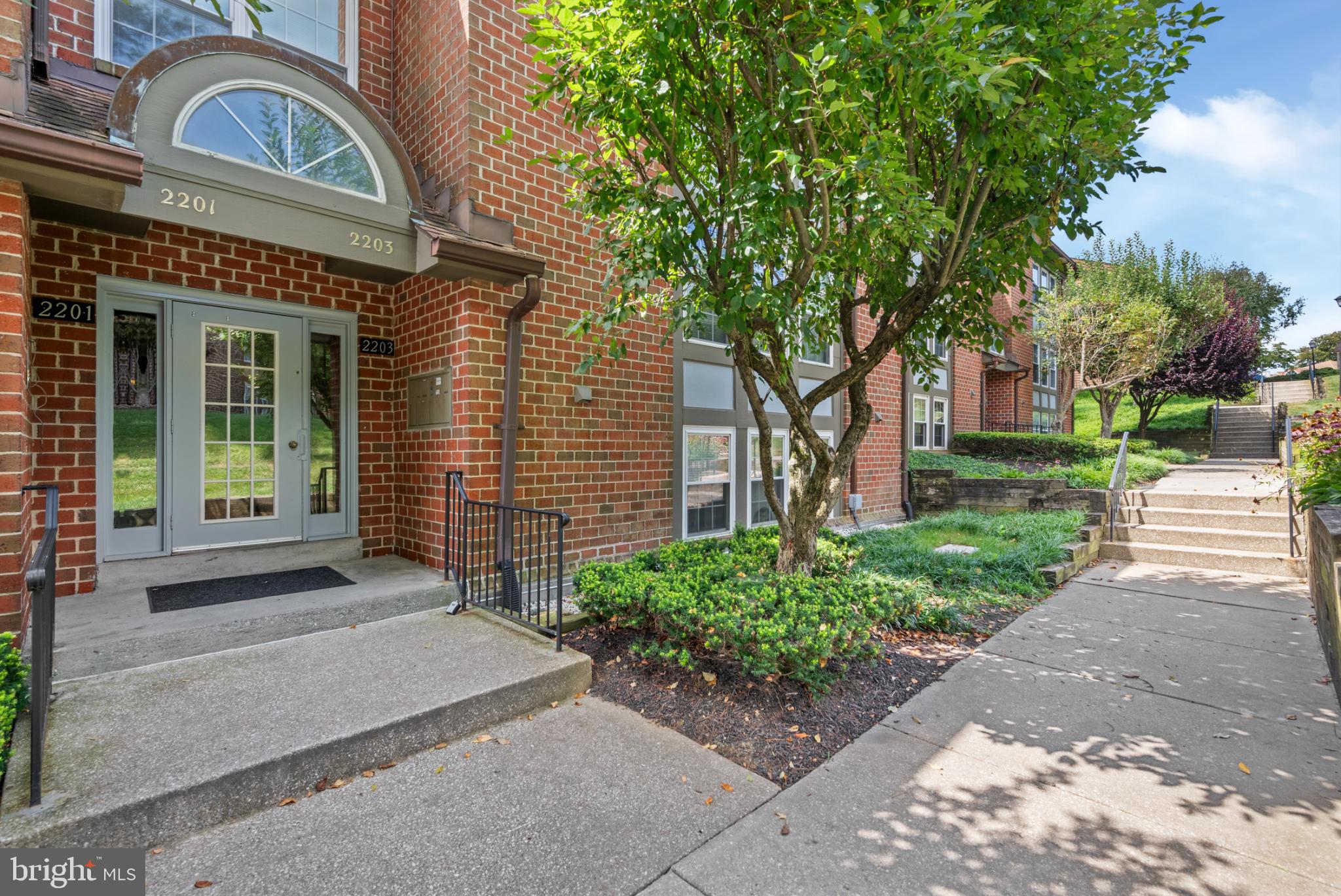 2201 Woodbox Lane, Unit 2201B Baltimore, MD 21209 - Photo 3 of 45 a front view of a house with garden