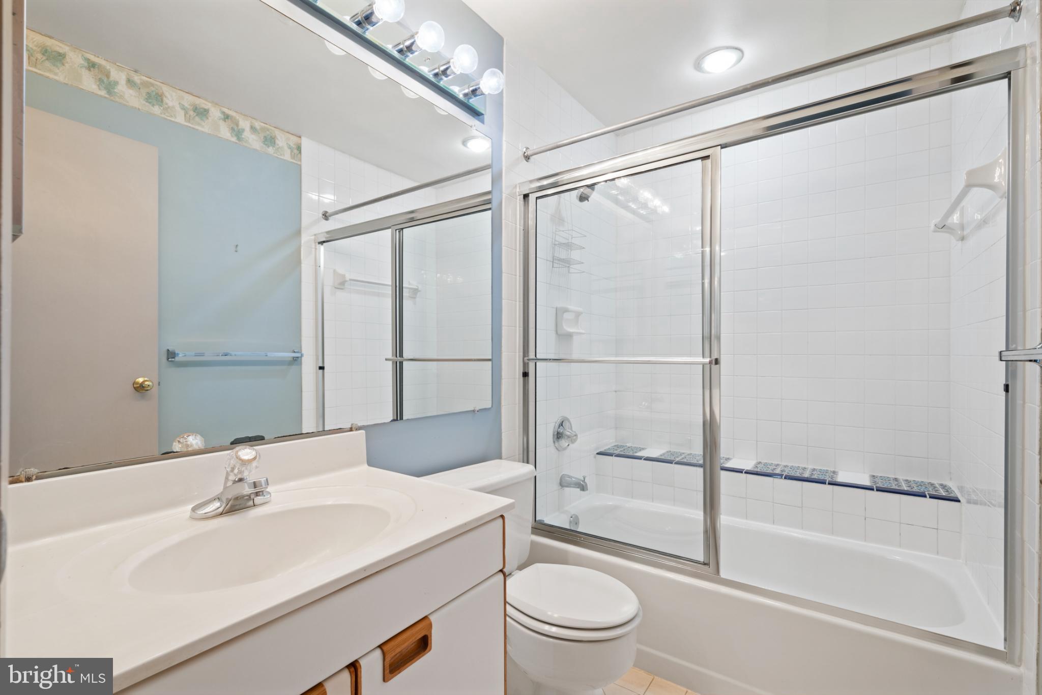2201 Woodbox Lane, Unit 2201B Baltimore, MD 21209 - Photo 35 of 45 a bathroom with a sink toilet and shower