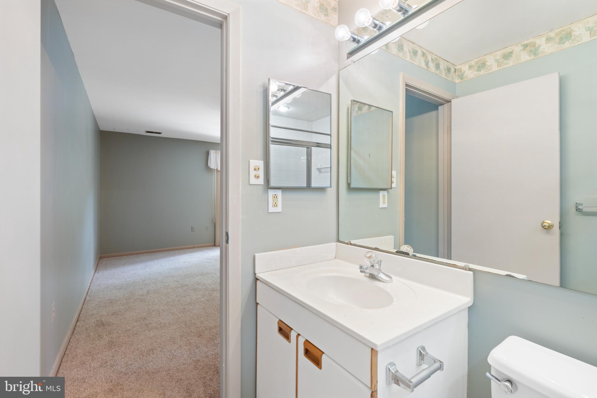 2201 Woodbox Lane, Unit 2201B Baltimore, MD 21209 - Photo 38 of 45 a bathroom with a sink toilet and mirror