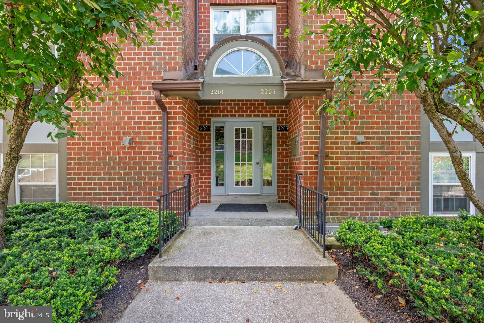 2201 Woodbox Lane, Unit 2201B Baltimore, MD 21209 - Photo 4 of 45 a front view of a house with a garden