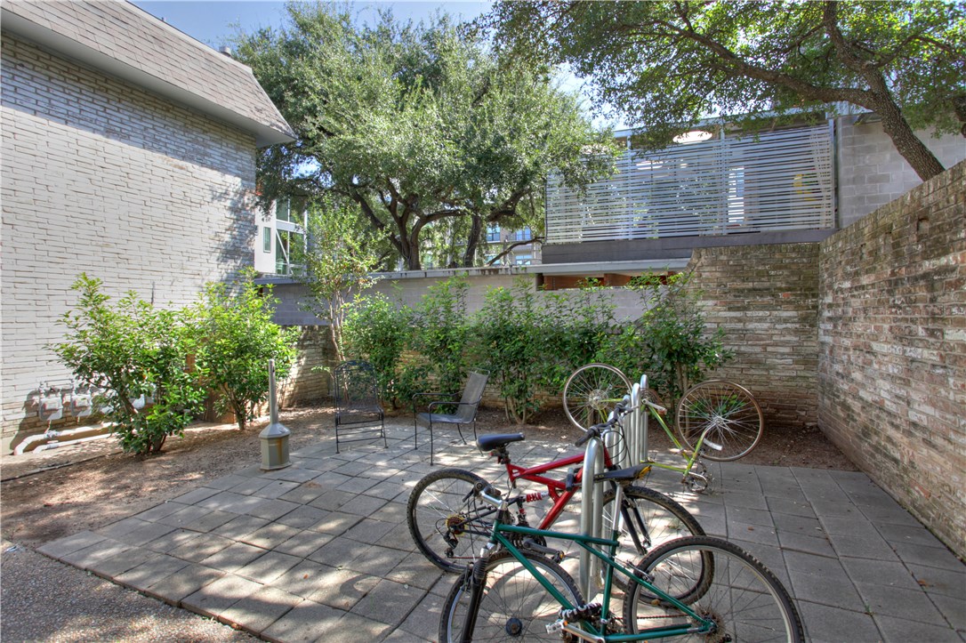 816 West N Loop Boulevard, Unit 106 Austin, TX 78756 - Photo 18 of 21 a backyard of a house with table and chairs and plants